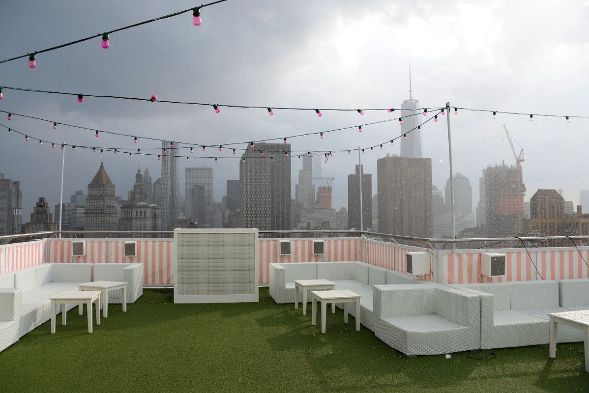 07-09 Outdoor Bar Vacated In The Rain With View To World Trade Center And Financial District From The Rooftop At NoMo SoHo New York City